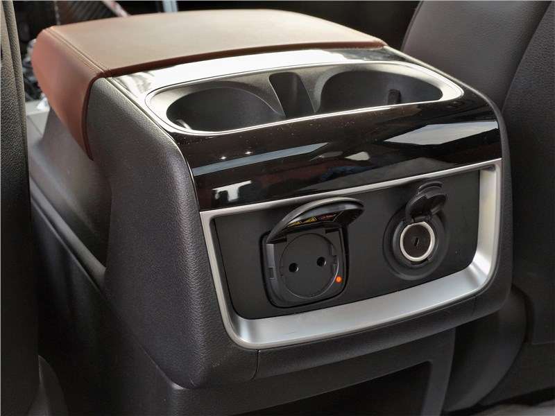 Фото KIA Carnival - В торце центрального бокса-подлокотника выполнены розетки на 12 и 220 В