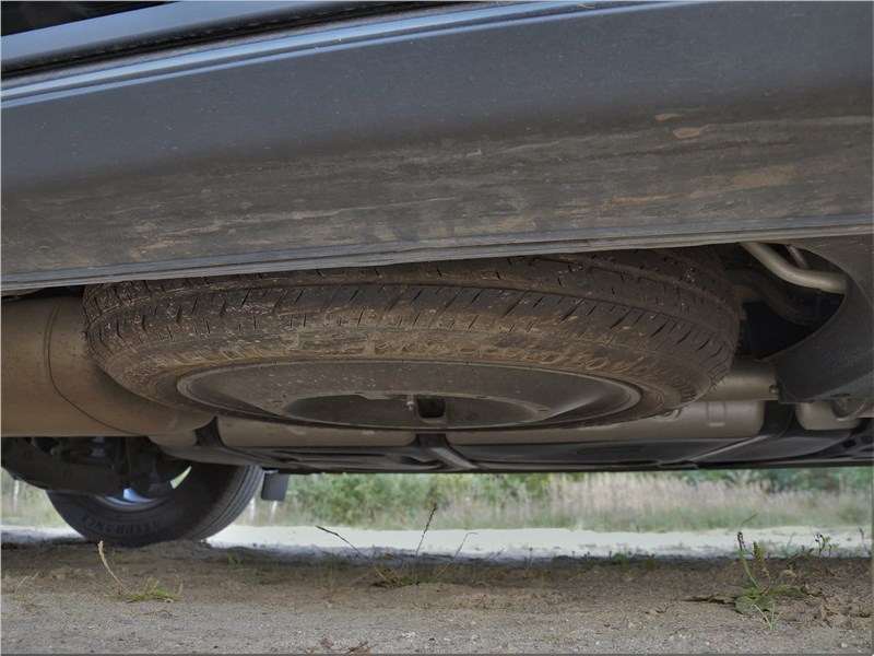 Фото KIA Carnival - Запасное колесо расположено под днищем, но не сзади, а сбоку — справа. Для извлечения его служит специальный ключ
